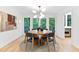 Bright dining room featuring a round table, modern chandelier, and access to the outdoor deck at 4601 Tall Pines Nw Dr, Atlanta, GA 30327