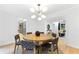 Dining area with round table and modern lighting, open to the rest of the house at 4601 Tall Pines Nw Dr, Atlanta, GA 30327