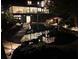 A modern-style house with a pool in the backyard, captured at dusk at 4601 Tall Pines Nw Dr, Atlanta, GA 30327