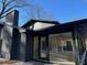 Modern home with a brick chimney, large windows providing ample light, and glass doors leading to the outside at 4601 Tall Pines Nw Dr, Atlanta, GA 30327