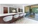 A stylish kitchen featuring a quartz countertop bar, modern stools, and an open view to an outdoor patio at 4601 Tall Pines Nw Dr, Atlanta, GA 30327
