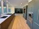 Modern kitchen with stainless appliances, custom cabinets, and hardwood flooring at 4601 Tall Pines Nw Dr, Atlanta, GA 30327