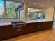 Long kitchen counter with stainless steel appliances, a range top, and stunning backyard views at 4601 Tall Pines Nw Dr, Atlanta, GA 30327