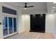 Bright living room features a painted brick fireplace, modern ceiling fan, and sliding glass doors at 4601 Tall Pines Nw Dr, Atlanta, GA 30327