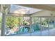 Bright living room with floor-to-ceiling windows overlooking natural stone pool and lush landscaping at 4601 Tall Pines Nw Dr, Atlanta, GA 30327