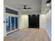 Bright living room features a painted brick fireplace, modern ceiling fan, and sliding glass doors at 4601 Tall Pines Nw Dr, Atlanta, GA 30327