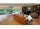 An expansive living room boasts a fireplace, hardwood floors, and views of the lush outdoor landscape at 4601 Tall Pines Nw Dr, Atlanta, GA 30327