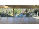 Sunlit living room with floor-to-ceiling windows that overlook the stone pool and lush greenery at 4601 Tall Pines Nw Dr, Atlanta, GA 30327