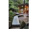 Beautiful backyard pond featuring a fountain and stone walkway to a covered patio at 4601 Tall Pines Nw Dr, Atlanta, GA 30327