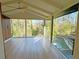 Bright sunroom with floor-to-ceiling windows, hardwood flooring, and views of the pool and surrounding greenery at 4601 Tall Pines Nw Dr, Atlanta, GA 30327