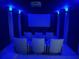 Home theater room with blue lighting, comfortable seating, and a large screen for immersive entertainment at 4601 Tall Pines Nw Dr, Atlanta, GA 30327