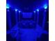 Home theater room with blue lighting, comfortable seating, and a large screen for immersive entertainment at 4601 Tall Pines Nw Dr, Atlanta, GA 30327