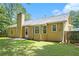 Well-maintained backyard featuring a grassy lawn, a patio, and mature trees for shade at 7847 Dogwood Way, Douglasville, GA 30134