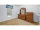 Bedroom with dresser and large window features neutral walls and carpeted floors at 7847 Dogwood Way, Douglasville, GA 30134