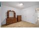 Bedroom with large dresser and mirror features neutral walls and carpeted floors at 7847 Dogwood Way, Douglasville, GA 30134