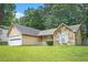 Single-story home featuring stone accents, a well-manicured lawn, and an attached two-car garage at 7847 Dogwood Way, Douglasville, GA 30134