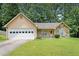 Charming single-story home with a two-car garage, stone accents, and a well-maintained lawn at 7847 Dogwood Way, Douglasville, GA 30134