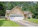 Charming home exterior with a garage, stone accents, and a well-manicured lawn at 7847 Dogwood Way, Douglasville, GA 30134