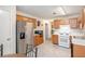 Traditional kitchen featuring stainless steel refrigerator and natural wood cabinets at 7847 Dogwood Way, Douglasville, GA 30134