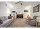 Bright living room featuring a stone fireplace, ceiling fan, and comfortable seating at 7847 Dogwood Way, Douglasville, GA 30134