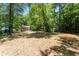 Large, mostly cleared backyard shaded by mature trees offers space and privacy at 2174 Rexford Dr, Decatur, GA 30034