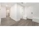 Finished basement hallway featuring fresh white walls and trim, and wood-look flooring at 2174 Rexford Dr, Decatur, GA 30034