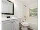 Bathroom with white subway tile, wood-look floors, toilet, shower and vanity with mirror at 2174 Rexford Dr, Decatur, GA 30034