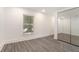 Neutral bedroom with a mirrored closet door and a window with natural light at 2174 Rexford Dr, Decatur, GA 30034