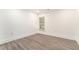 Clean, minimalist bedroom with light flooring, white walls, and a bright window at 2174 Rexford Dr, Decatur, GA 30034