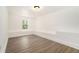 Bedroom featuring wood-look floors, a window and fresh white walls and trim at 2174 Rexford Dr, Decatur, GA 30034