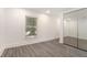 Bright bedroom featuring a mirrored closet, light flooring, and a window, creating a serene space at 2174 Rexford Dr, Decatur, GA 30034