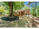 Charming brick home featuring a cozy front porch and beautiful landscaping around a mature tree at 2174 Rexford Dr, Decatur, GA 30034