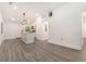 Open living space flows seamlessly into a modern kitchen with stainless appliances and gray wood flooring at 2174 Rexford Dr, Decatur, GA 30034