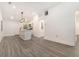 Open-concept living area with a kitchen island, modern lighting, and sleek flooring, perfect for entertaining at 2174 Rexford Dr, Decatur, GA 30034