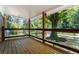 Inviting covered porch featuring wood floors and railing with a lovely view of the surrounding yard at 2174 Rexford Dr, Decatur, GA 30034
