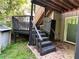 Back porch with weathered stairs, railing, and gate, leading to a deck and access to the yard at 3230 Plymouth Rock Dr, Douglasville, GA 30135
