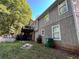 Backyard showing the home, landscaping and a recycling bin at 3230 Plymouth Rock Dr, Douglasville, GA 30135