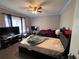 This bedroom features two beds, a ceiling fan, and a window with curtains at 3230 Plymouth Rock Dr, Douglasville, GA 30135