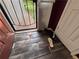 Entryway foyer with damaged wood flooring and a storm door at 3230 Plymouth Rock Dr, Douglasville, GA 30135