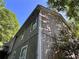 Exterior shot of a two-story home displaying the siding and window details against a blue sky and lush trees at 3230 Plymouth Rock Dr, Douglasville, GA 30135
