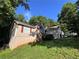 Exterior of the home showing brick and siding details, landscaped lawn, and surrounding trees at 3230 Plymouth Rock Dr, Douglasville, GA 30135