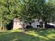 Charming home nestled among mature trees, featuring a well-maintained lawn and inviting curb appeal at 3230 Plymouth Rock Dr, Douglasville, GA 30135