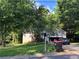 Suburban home nestled among mature trees, featuring a driveway and inviting curb appeal at 3230 Plymouth Rock Dr, Douglasville, GA 30135