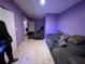 Living room featuring a comfortable sofa, tile flooring, and purple walls at 3230 Plymouth Rock Dr, Douglasville, GA 30135