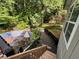 View of a backyard deck, pool, and lush greenery at 3230 Plymouth Rock Dr, Douglasville, GA 30135
