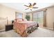 Comfortable bedroom featuring a ceiling fan, bedside table, and natural light from the window at 3495 Mill Bridge Dr, Marietta, GA 30062