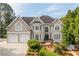 Charming two-story home features a manicured front lawn, two-car garage, and classic architectural details at 3495 Mill Bridge Dr, Marietta, GA 30062