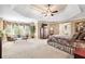 Spacious main bedroom featuring a sitting area, tray ceiling, and large windows at 3495 Mill Bridge Dr, Marietta, GA 30062