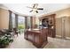 Well-lit home office with a large desk, built-in shelving, and comfortable seating at 3495 Mill Bridge Dr, Marietta, GA 30062