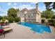 Gorgeous pool with a waterfall feature, lounge chairs, and beautifully landscaped backyard at 3495 Mill Bridge Dr, Marietta, GA 30062